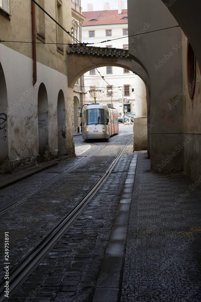 Petite rue sombre avec tramway au fond à Pargue
