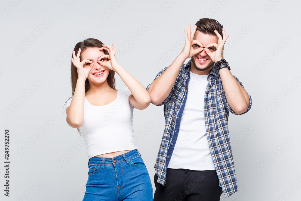 Young happy friends wearing at casual style joying together on white background. Young happy friends wearing at casual style joying together on white background.