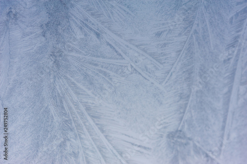 Close up of abstract patterns of ice forming on a frozen windshield