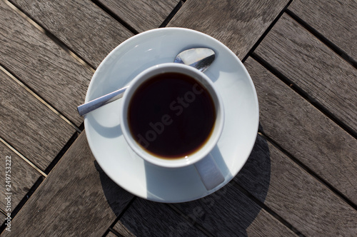 cup of tea on a saucer on a wooden table