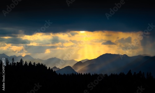 sunset in bavarian alps with mountain silhouettes in front