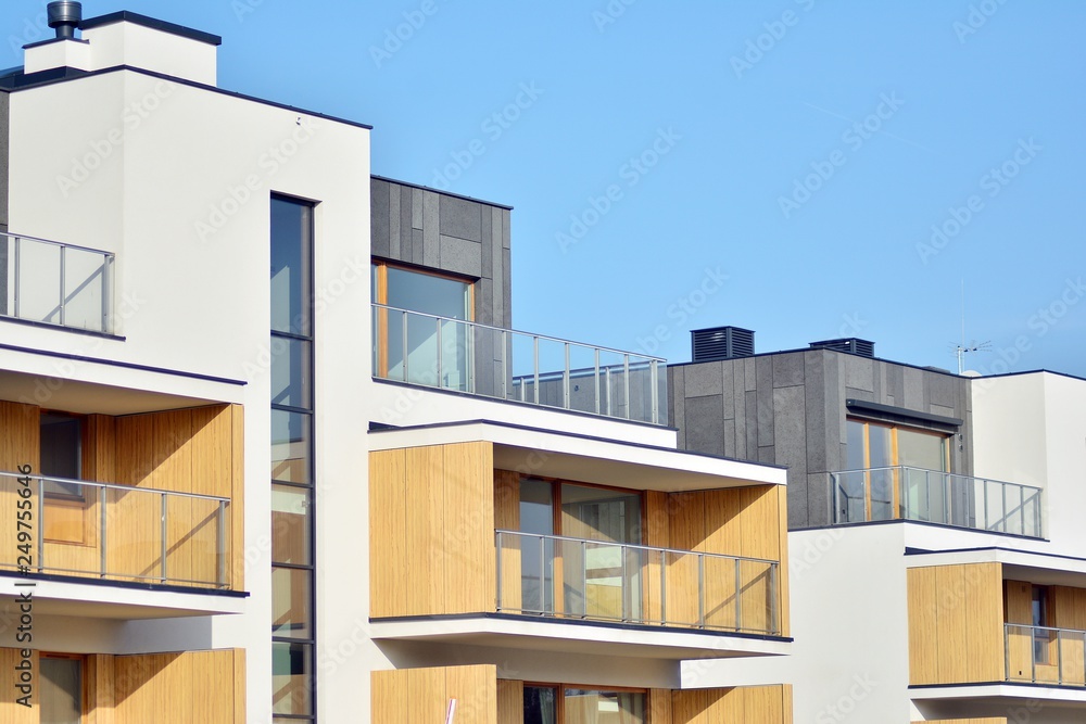 Modern apartment buildings on a sunny day with a blue sky. Facade of a modern apartment building Modern apartment buildings on a sunny day with a blue sky. Facade of a modern apartment building