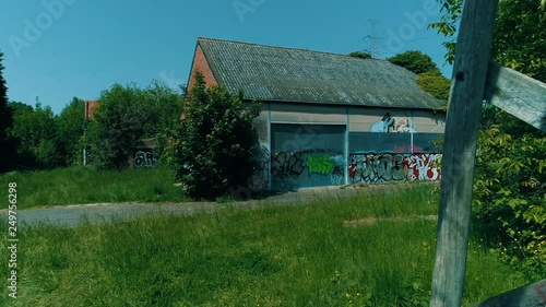 creepy abandoned ghost town, steady shot through a swing that slowely moves in the wind photo