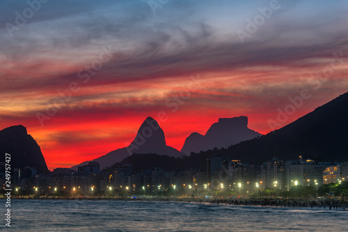 Night View of Copacabana Beach With Beautiful Red Sky Just After the Sunset  and Mountains in the Horizon  in Rio de Janeiro  Brazil