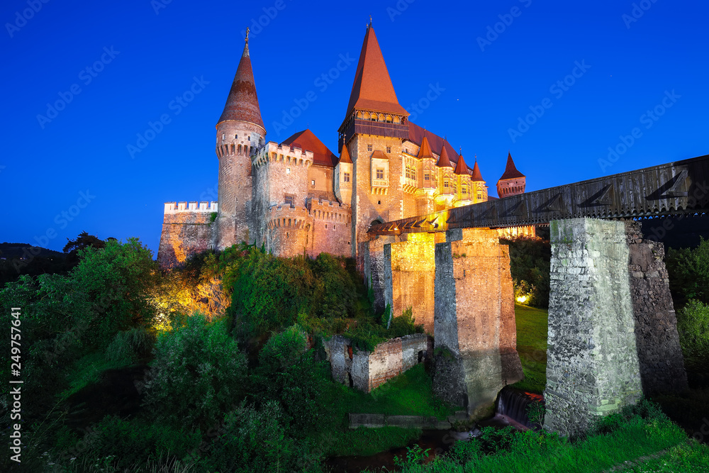 Beautiful night panorama of the Hunyad Castle / Corvin's Castle with wooden bridge.