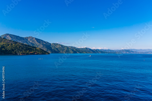 A Tranquil Sea with Mountains in the background