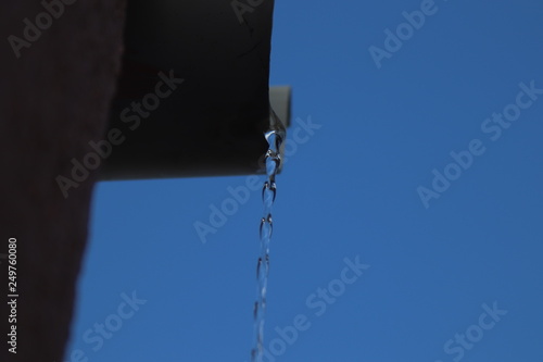 Canaleta de agua en cielo azul photo