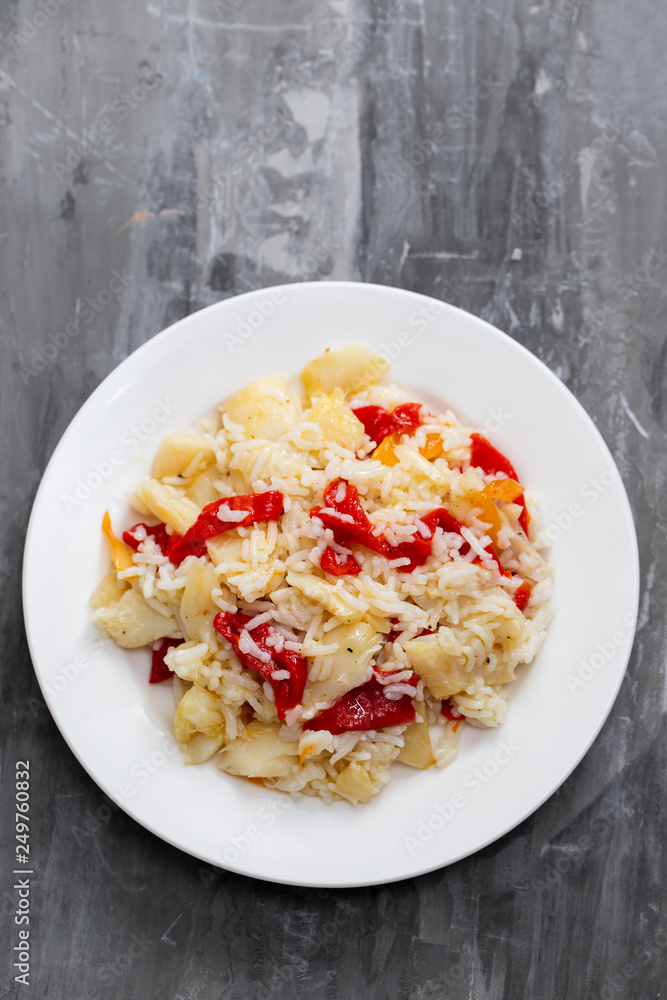 rice with cod fish and red pepper on white plate rice with cod fish and red pepper on white plate