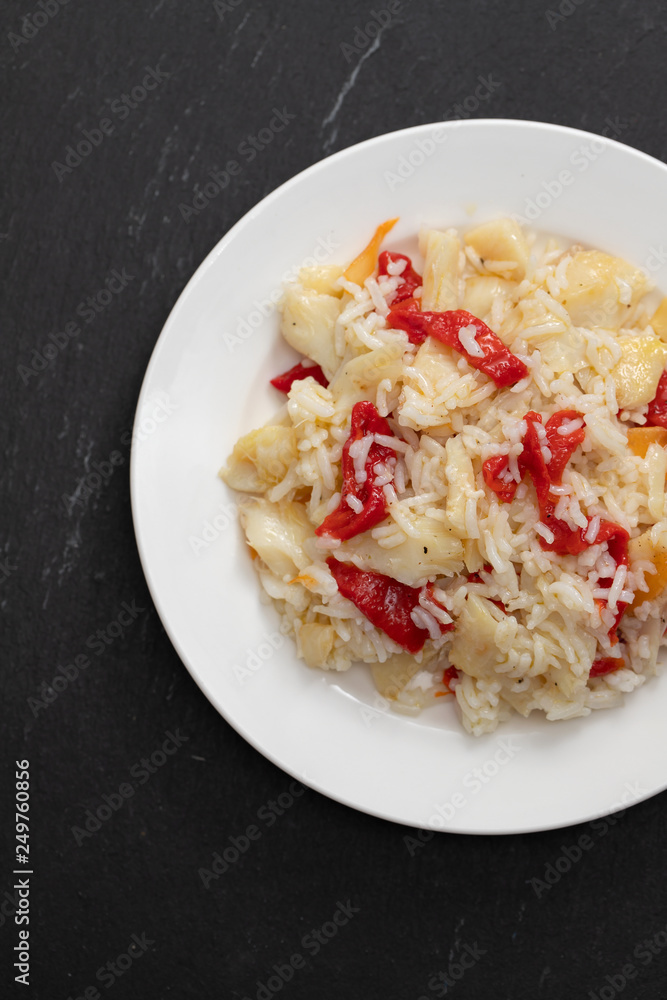 rice with cod fish and red pepper on white plate rice with cod fish and red pepper on white plate