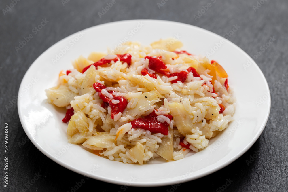 rice with cod fish and red pepper on white plate rice with cod fish and red pepper on white plate