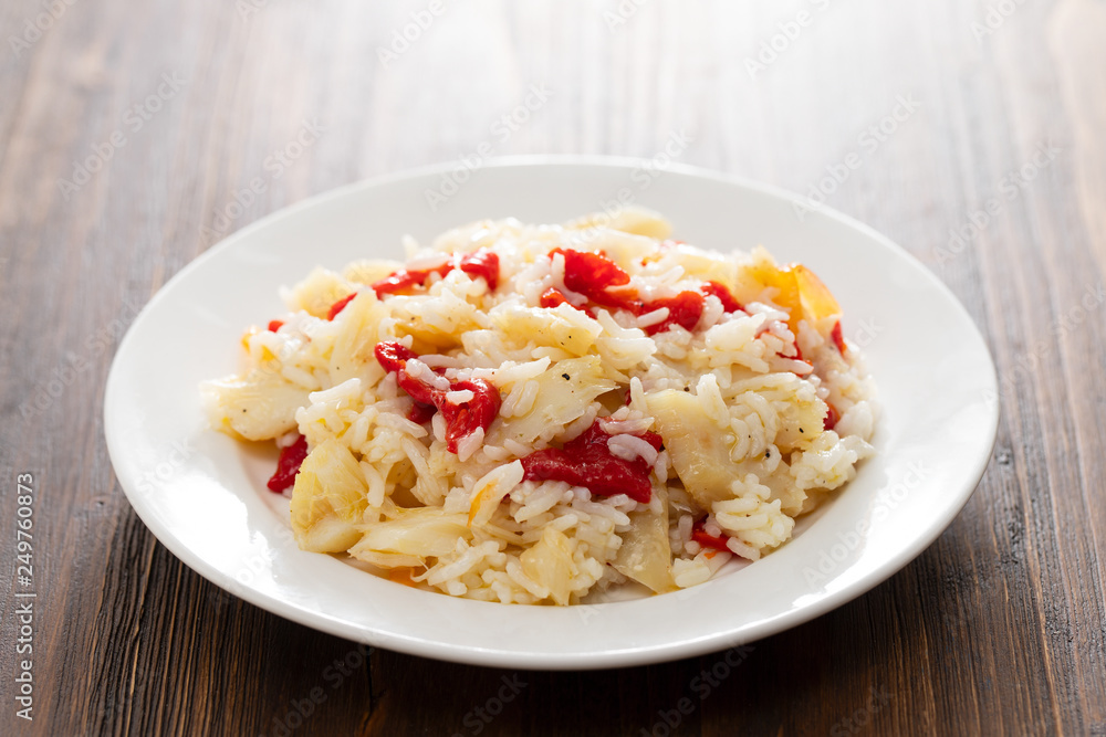 rice with cod fish and red pepper on white plate rice with cod fish and red pepper on white plate