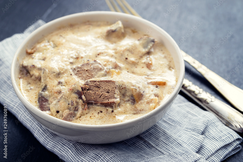 liver with sauce on dish on ceramic background liver with sauce on dish on ceramic background