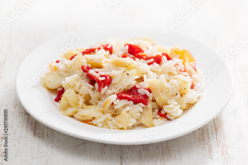 rice with cod fish and red pepper on white plate