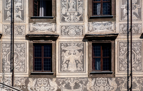 Sgraffito wall decor at front of historical building with fairies and angels