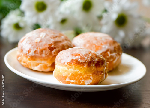 Homemade donuts on white plate with flowers