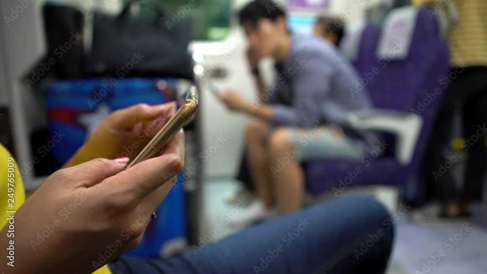 4K, Busy asian woman messaging on the smartphone inside of subway. Girl having mobile phone conversation indoor of train. People travelers using device phone during travel-Dan 4K, Busy asian woman messaging on the smartphone inside of subway. Girl having mobile phone conversation indoor of train. People travelers using device phone during travel-Dan