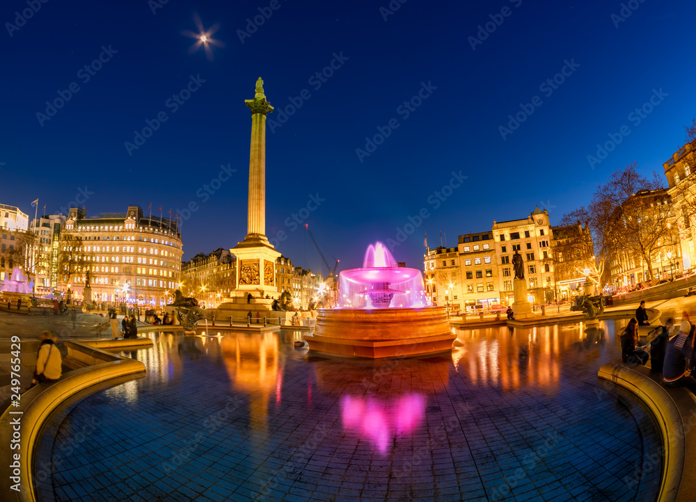 Cityscape view of Trafalgar square at dusk with the famous Nelson's Column and fountain in Central London