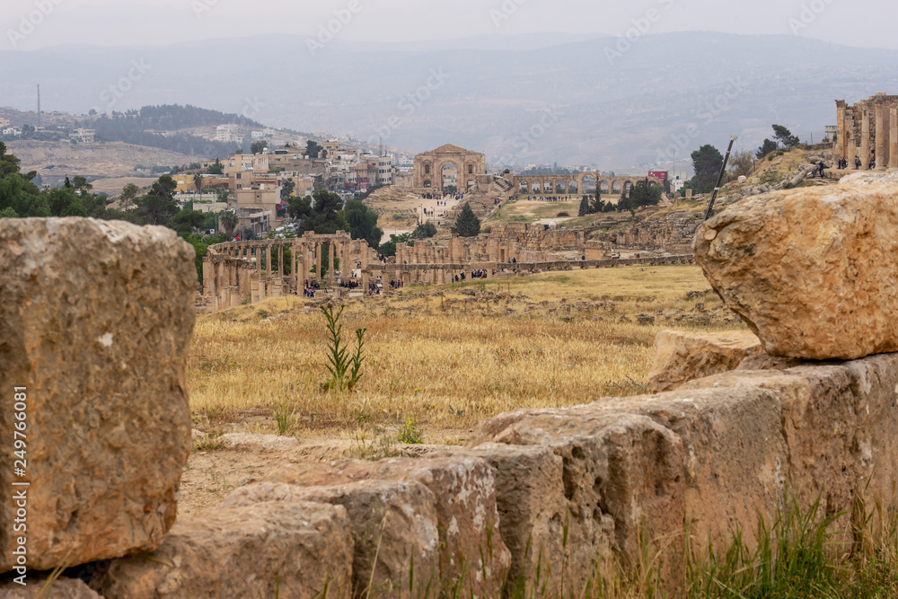 View of Hadrian's Arch and Hyppodrome through the ruins in the Roman city of Jerash, Jordan