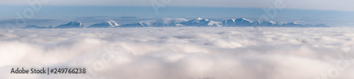 The peaks of the snowy mountains above the clouds © Tom