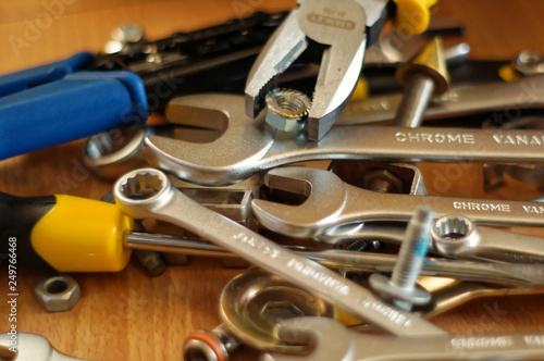 Do It Yourself DIY accessories - locksmith tools, wrenches, screwdrivers, pliers, nuts and bolts on a wooden table