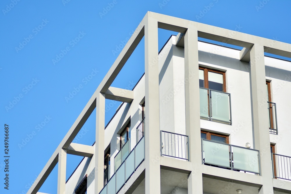 Modern apartment buildings on a sunny day with a blue sky. Facade of a modern apartment building Modern apartment buildings on a sunny day with a blue sky. Facade of a modern apartment building
