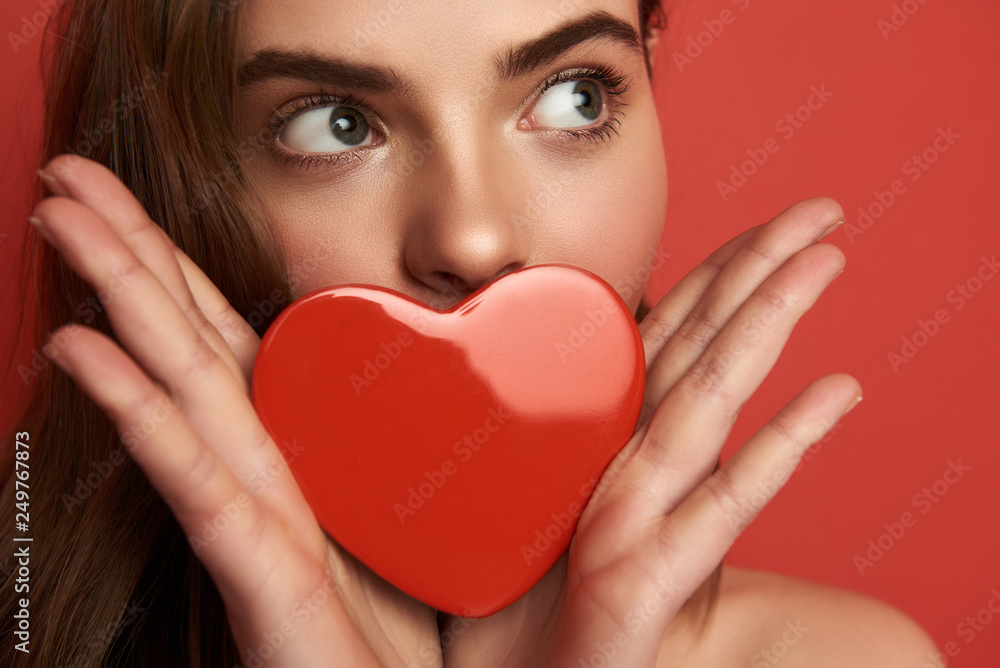 Portrait of pretty woman with brown hair looking aside on color background Portrait of pretty woman with brown hair looking aside on color background