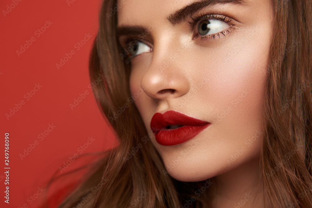 Cropped photo of charming lady looking away on red background Cropped photo of charming lady looking away on red background