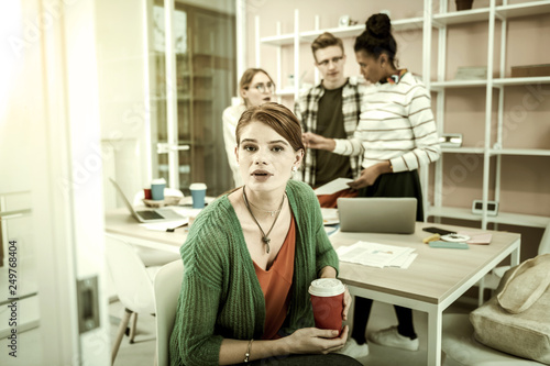 Beautiful student having little coffee break after group study