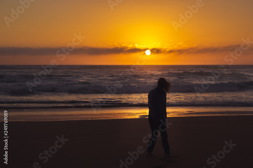 carefree woman dancing in the sunset on the beach. vacation vitality healthy living concept  Australia
