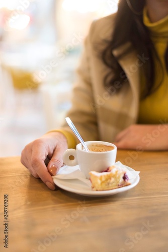 girl holding cup of espresso coffee