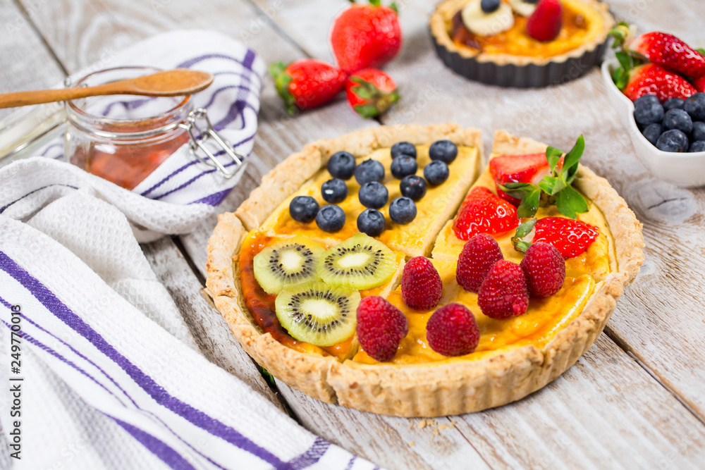 Fruit tarts with sweet fresh berries. Freshly baked cake. Decorated with a  berry. Fruit pie. - Image