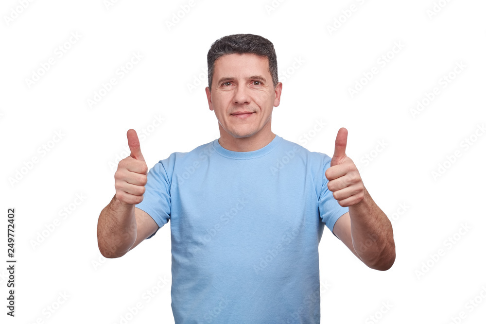 Handsome middle-aged man with a slight smile, showing thumbs up with two hands. Handsome middle-aged man with a slight smile, showing thumbs up with two hands.