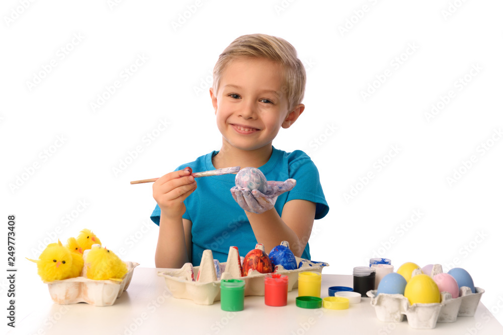The child is painting Easter eggs. The child is painting Easter eggs.