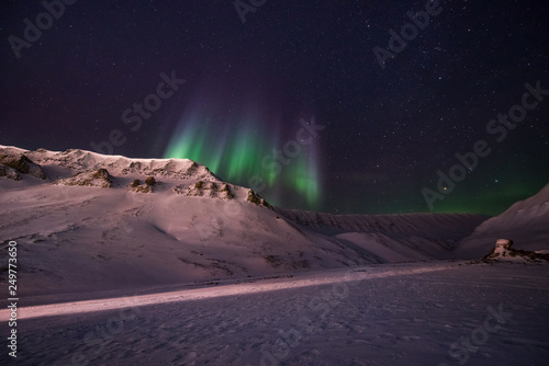 The polar arctic Northern lights aurora borealis sky star in Norway travel Svalbard in Longyearbyen city the moon mountains