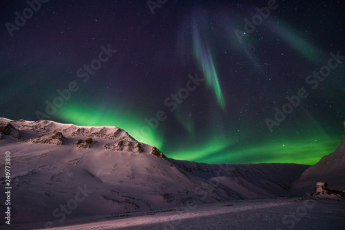 The polar arctic Northern lights aurora borealis sky star in Norway travel Svalbard in Longyearbyen city the moon mountains