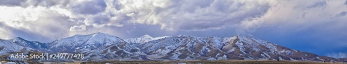 inter Panorama of Oquirrh Mountain range snow capped, which includes The Bingham Canyon Mine or Kennecott Copper Mine, rumored the largest open pit copper mine in the world in Salt Lake Valley, Utah. 