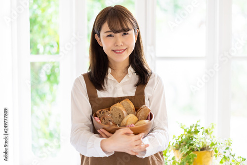attractive asian woman holding bread