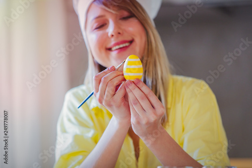 female as chef painting eggs for Easter Holiday