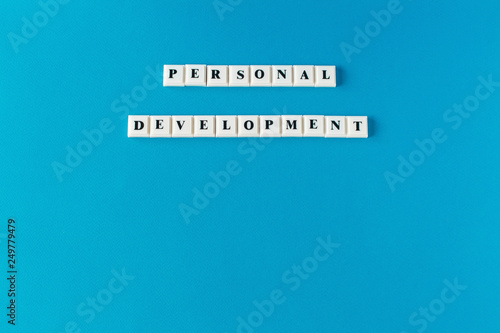 Personal development. Isolated text written on blue background