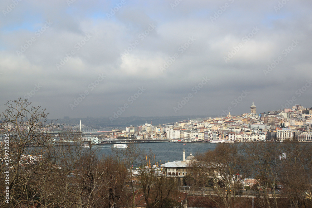 View of Istanbul through the Bosphorus and Golden Horn. Urban landscape with Galata Tower. Travel photography. Cloudy spring day. View of Istanbul through the Bosphorus and Golden Horn. Urban landscape with Galata Tower. Travel photography. Cloudy spring day.