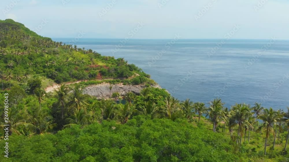 Aerial view of the small island of Nusa Penida Island from the Atuh Rija Lima shrine on Nusa Penida Island near Bali, Indonesia.Nusa Penida island aerial view beach from drone. Travel Indoneesia. Aerial view of the small island of Nusa Penida Island from the Atuh Rija Lima shrine on Nusa Penida Island near Bali, Indonesia.Nusa Penida island aerial view beach from drone. Travel Indoneesia.