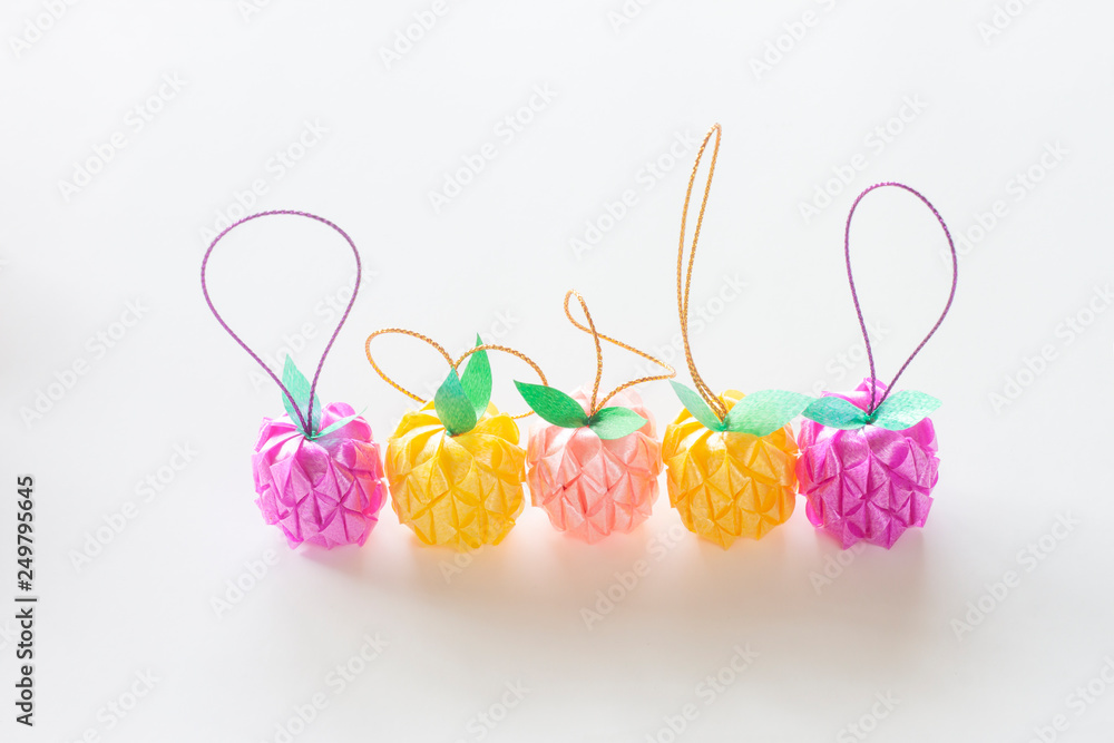Fold the ribbon into the fruit and put the coin inside for donate in buddhism isolated on white background. Fold the ribbon into the fruit and put the coin inside for donate in buddhism isolated on white background.