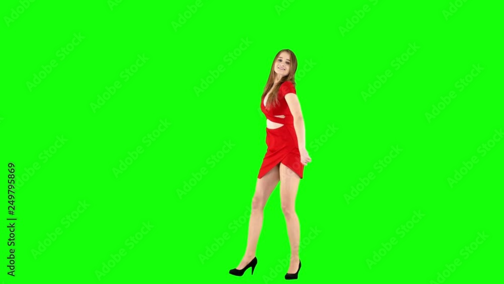 Woman in Red Dress Smiling at The Camera and Dancing on Green Screen Woman in Red Dress Smiling at The Camera and Dancing on Green Screen