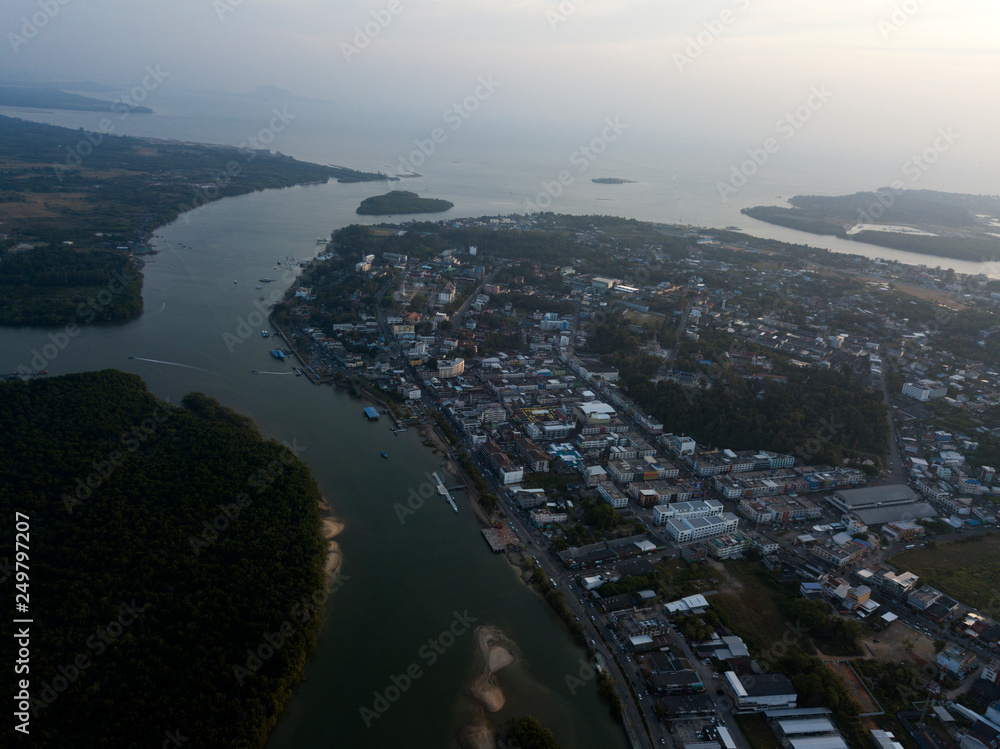 Fototapeta premium Image from drone of river in Krabi town, Thailand. Green trees, mountains and rocks around river.