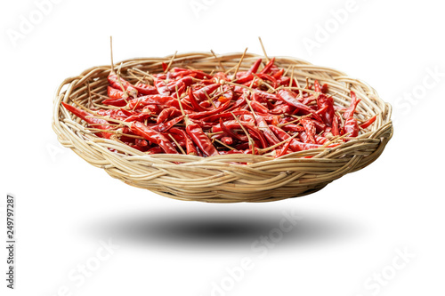 Dried peppers in a wicker basket isolated on white background.
