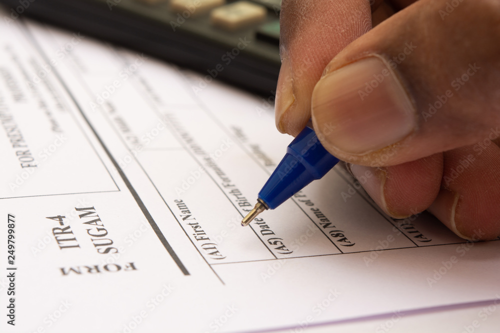 Close up of Concept showing of filling Indian Income tax form ITR 4 Close up of Concept showing of filling Indian Income tax form ITR 4
