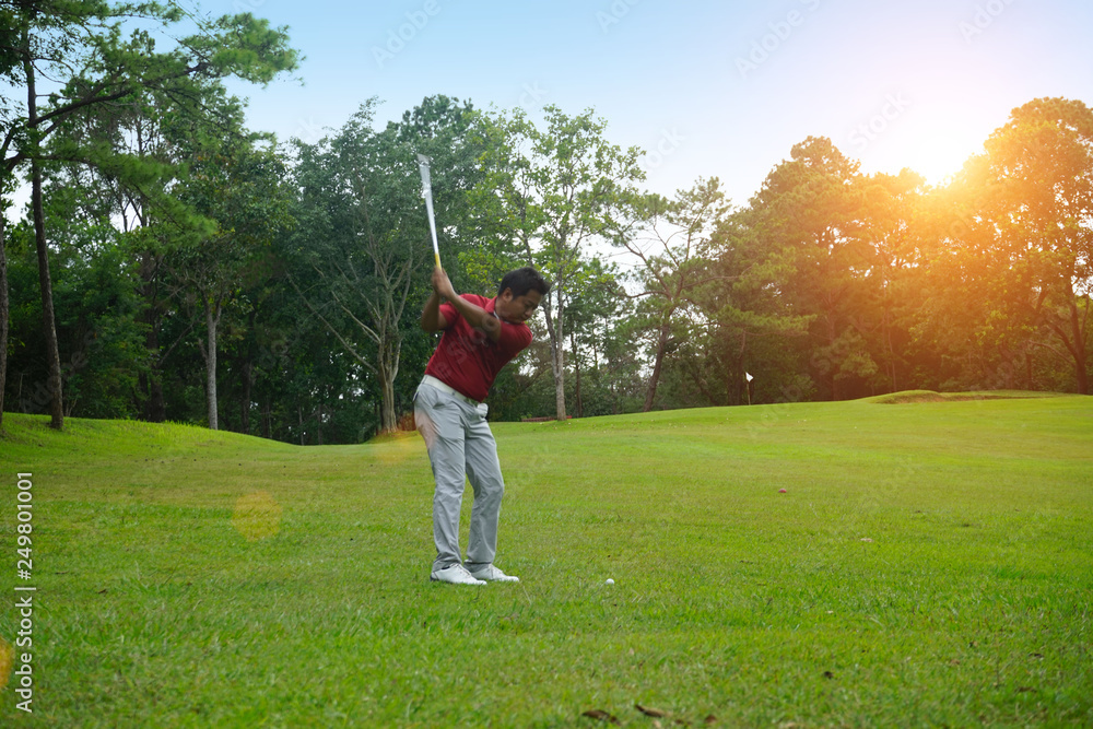 Blurred golfer playing golf in beautiful golf course in the evening golf course with sunshine in thailand Blurred golfer playing golf in beautiful golf course in the evening golf course with sunshine in thailand