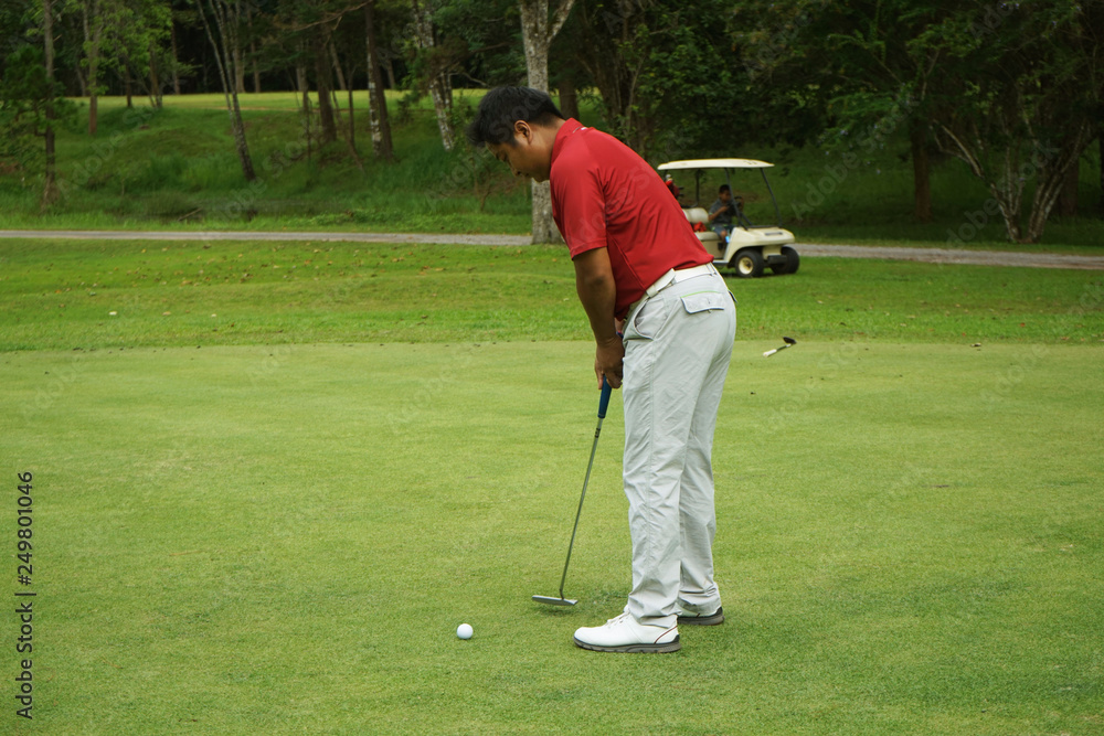 Fototapeta premium Blurred golfers are putting golf in the evening golf course golf backglound in Thailand