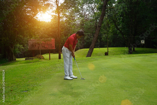 Blurred golfers are putting golf in the evening golf course golf backglound in Thailand photo