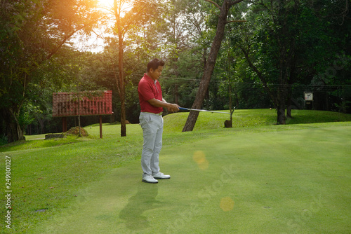 Blurred golfers are putting golf in the evening golf course golf backglound in Thailand